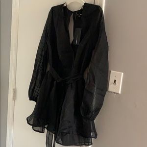 Black long sleeve romper. Tags attached